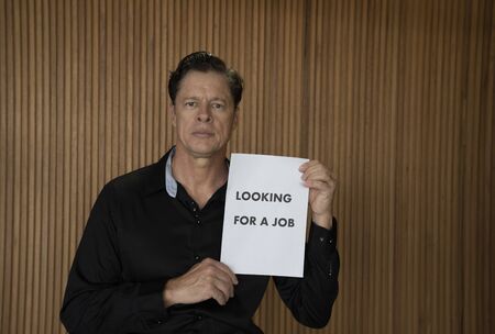 Looking for a job. COVID-19. The unemployed guy with sign LOOKING For A JOB. Unemployment during coronavirus COVID-19 crisis, the concept of job loss.の写真素材
