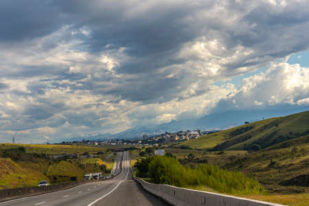 Beautiful highway and landscape. President Dutra Highway. City Cachoeira Paulista in the background. The famous road that connects the city o Rio de Janeiro and Sao Paulo, Brazil.の写真素材