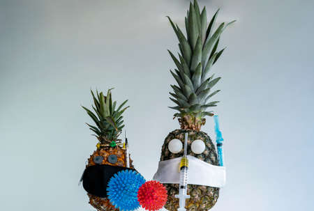 Wearing mask and vaccine. Pandemic, a portrait of a Pineapple wearing a protective mask.の写真素材