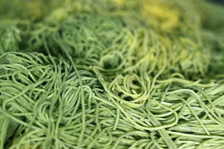 Raw green spaghetti noodles. The spaghetti is ready to cook. Top view.の写真素材