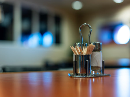 Salt shaker and pepper with toothpicks on the table.の写真素材