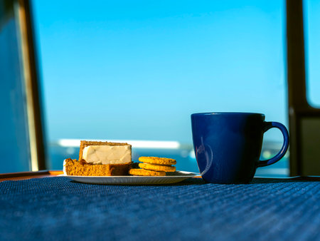 A cup of coffee with cookies on a table.の写真素材