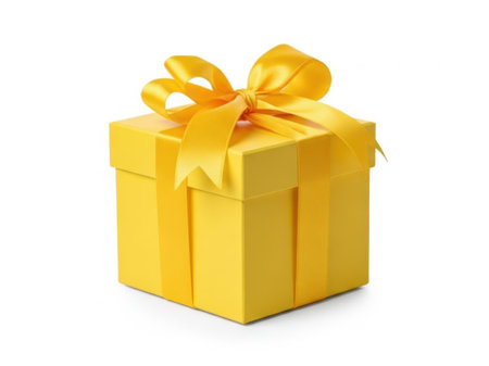 A vibrant yellow gift box adorned with a beautiful bow, ready for a special occasion.の素材