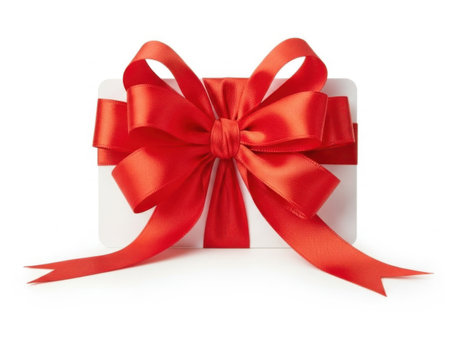 A pristine white gift box adorned with a large, luxurious red ribbon bow, exuding a festive and elegant charm.の素材