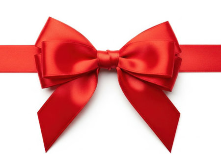 A single, beautifully crafted red ribbon bow set against a pristine white background, exuding a sense of celebration and elegance.の素材