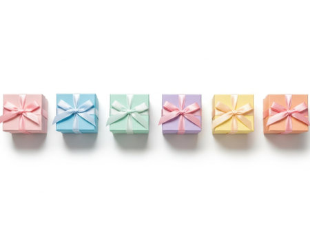 Six vibrant gift boxes arranged in a neat row, each with a bow on top, set against a plain white background.の素材