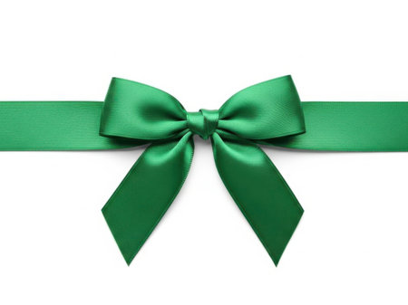 A single, beautifully crafted green ribbon bow sits elegantly on a plain white background, symbolizing celebration and gift-giving.の素材