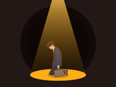 Businessman falls on his knees in spotlightの写真素材