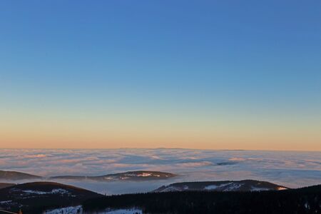 Rays of sunset on the tops of the mountains on a sunny day