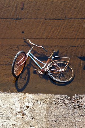 Abandoned bicycle under in a dam pool.の写真素材
