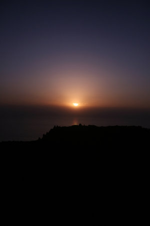 Sunset at the top of a mountain in Santorini, Greeceの写真素材