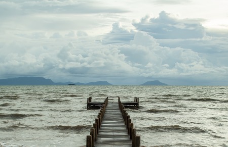 empty jetty and cloudy skyの写真素材