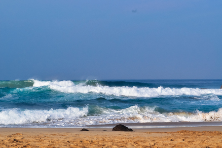Beautiful Waves on the Beach. Stone, Sand, and Water in Frameの写真素材