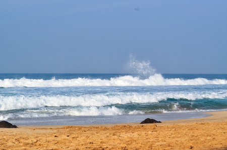 Beautiful Waves on the Beach. Stone, Sand, and Water in Frameの写真素材