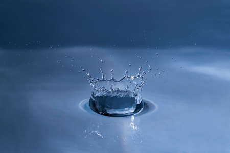 Splashing water drops causing wavy water surface