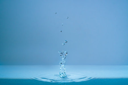 Water fountain and splashing drops above water surface