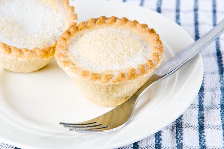 Two mince pies with a fork on a plateの写真素材