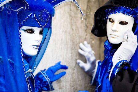 Two people in blue costumes at the Venice Carnivalの写真素材