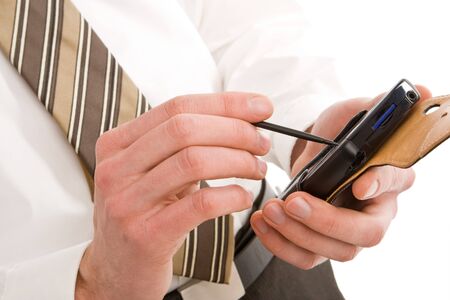 Business man using a pda isolated on whiteの写真素材