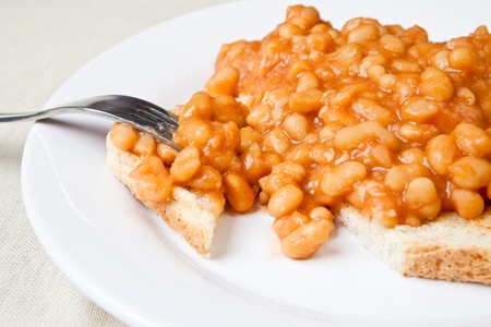 Delicous baked beans on toast with a forkの写真素材