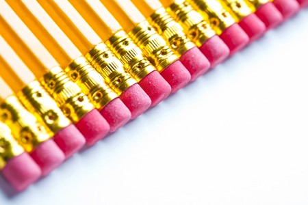 Yellow pencils with a rubber on the end in a straight lineの写真素材