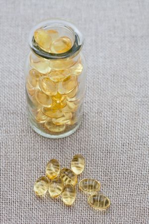 Cod liver oil capsules in a small jarの写真素材