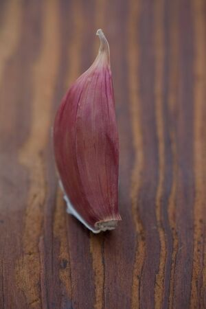 Clove of fresh garlic on a wooden boardの写真素材