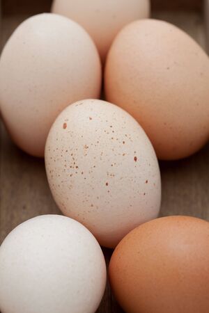 Close up of six fresh eggs in a wooden boxの写真素材