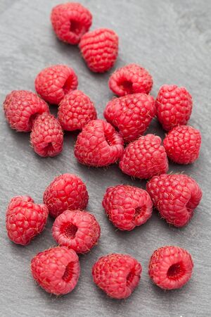 Fresh raspberries on a grey slate