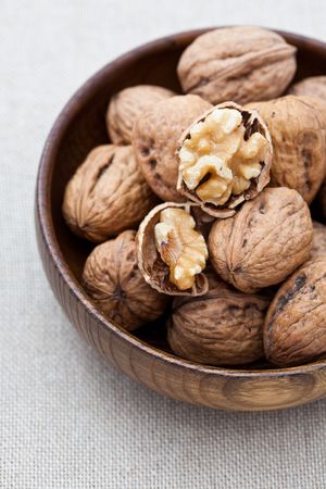 Walnuts in a brown wooden bowl