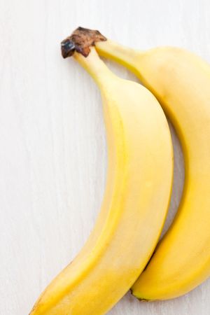 Two fresh bananas on a wooden boardの写真素材