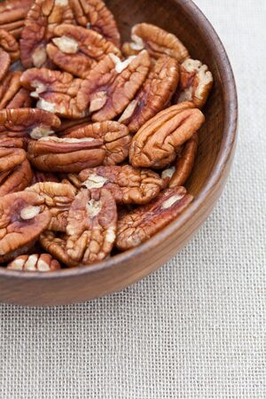 Pecan nuts in an old wooden bowl