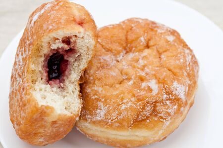 Two fresh donuts on a white plateの写真素材