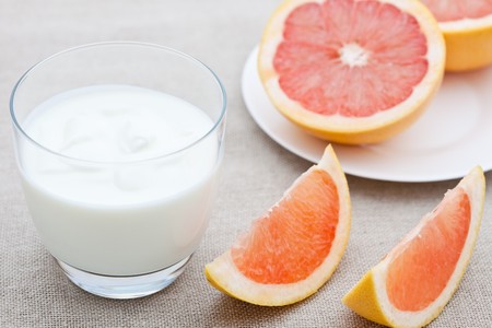 Glass of yogurt with segments of pink grapefruitの写真素材