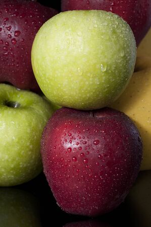 Close-up picture of several apples on black backgroundの写真素材