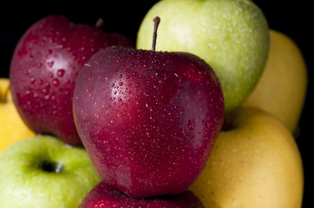 Close-up picture of several apples on black backgroundの写真素材