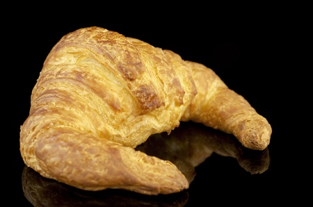 Fresh french croissant isolated on black.の写真素材