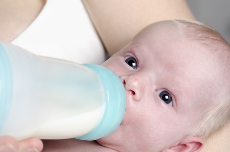 Close up photography of a newborn baby with bottleの写真素材