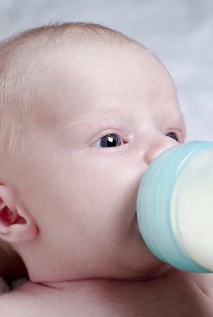 Close up photography of a newborn baby with bottleの写真素材