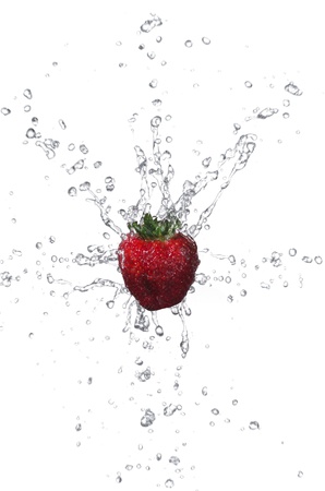 Fresh strawberry with water splashing on white backgroundの写真素材