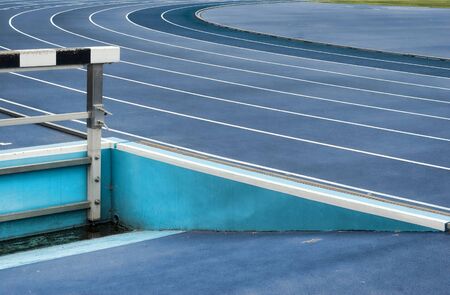 blue racing tracks and hurbles with empty basinの写真素材