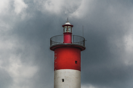 Lighthouse of Port-La-Nouvelle in red and white on cloudy sky in Occitanie, Franceの写真素材