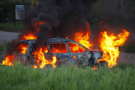 Burning car i the natureの写真素材