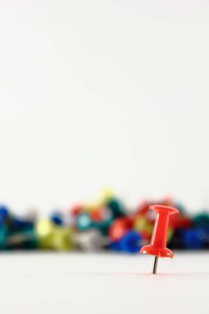 thumb pin in foreground isolated on whiteの写真素材