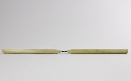 two pencils with their point connected together isolated over whiteの写真素材