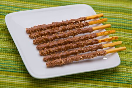 Chocolate covered sticks with coconut.の写真素材