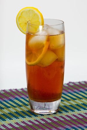 Iced tea with slices of lemon on place mat.の写真素材