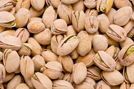 Background texture of salted, and roasted pistachio nuts in their shells.の写真素材