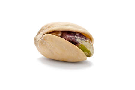 Single roasted and salted pistachio nut on white background.の写真素材