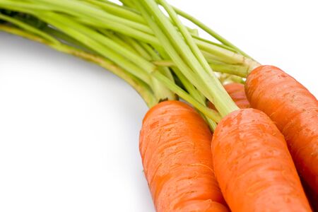 A bunch of fresh organic carrots on white background.の写真素材